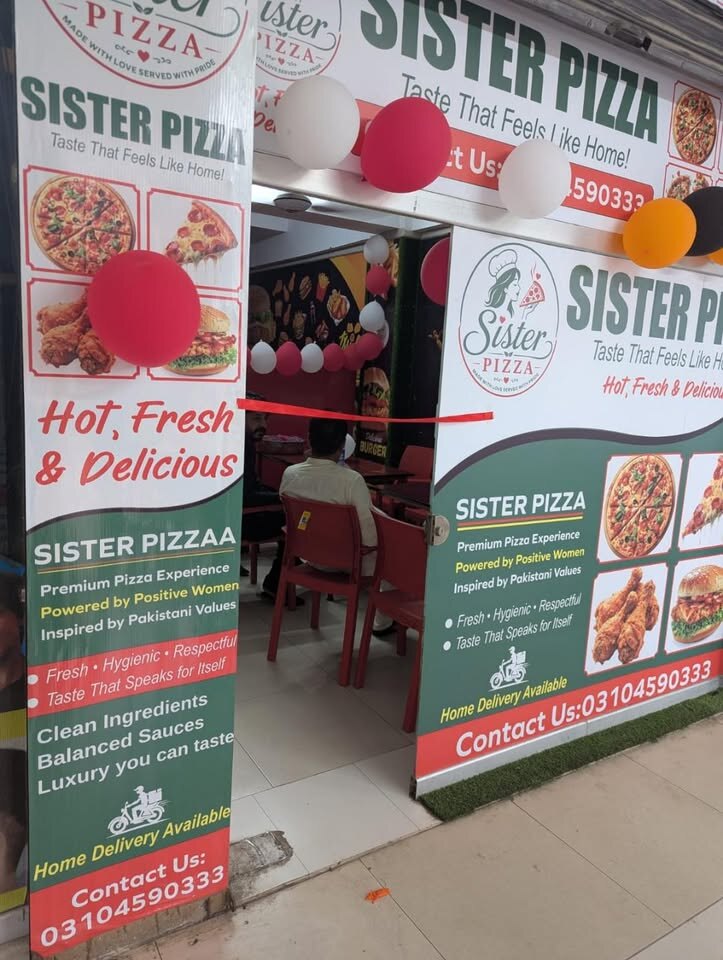 Sister Pizza storefront in Korang Town, Islamabad, decorated for opening day