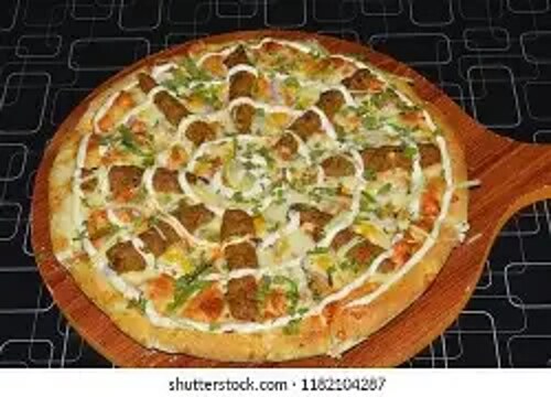 Seekh Kabab Pizza topped with kabab pieces and herbs